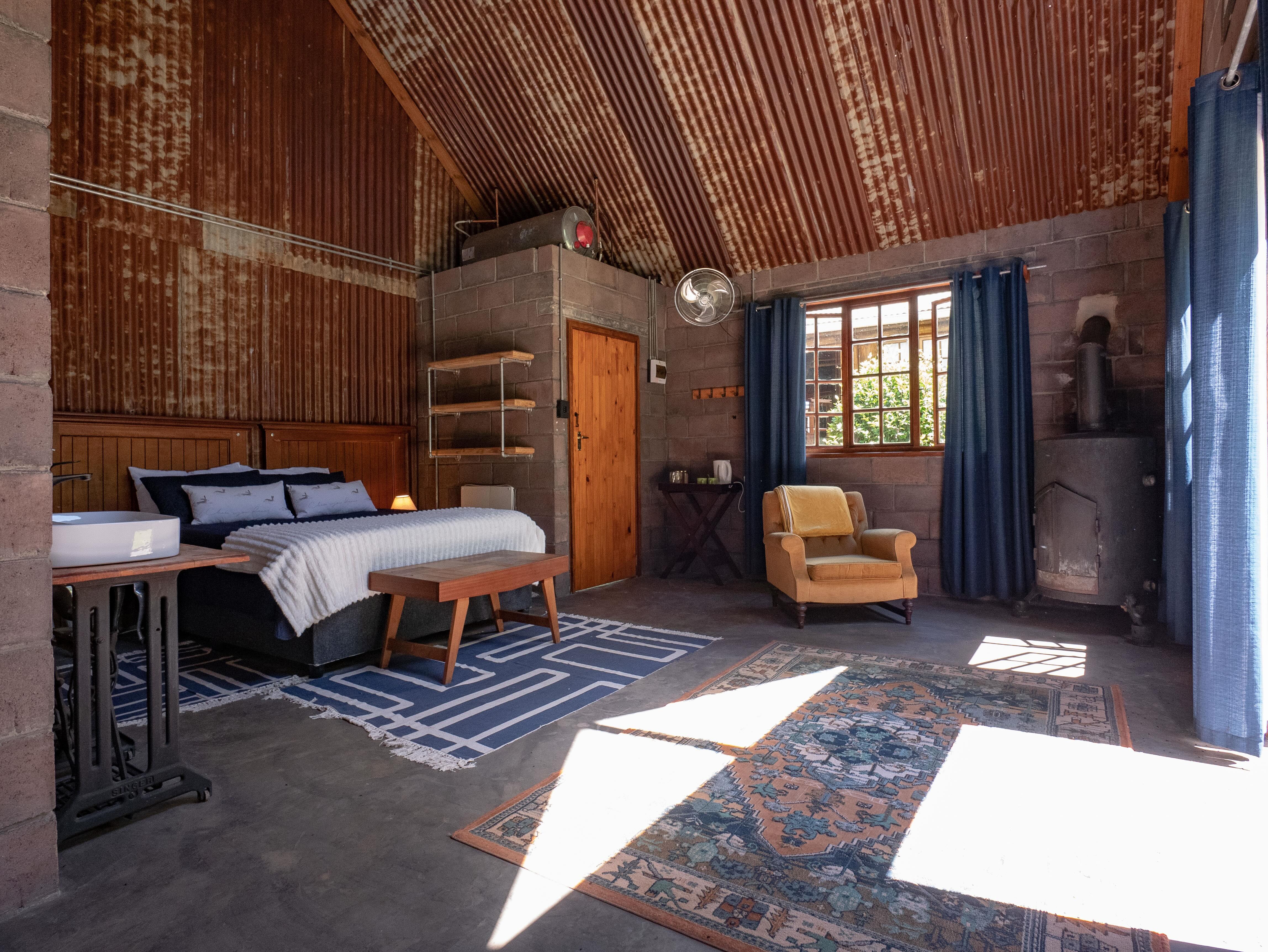 Cottage bedroom with armchair and fireplace