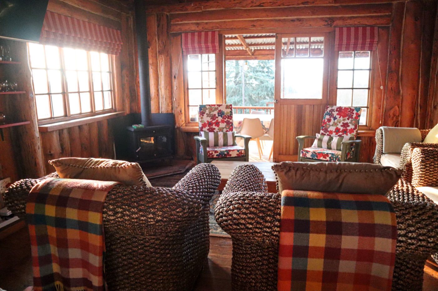 Log cabin lounge looking onto the covered deck