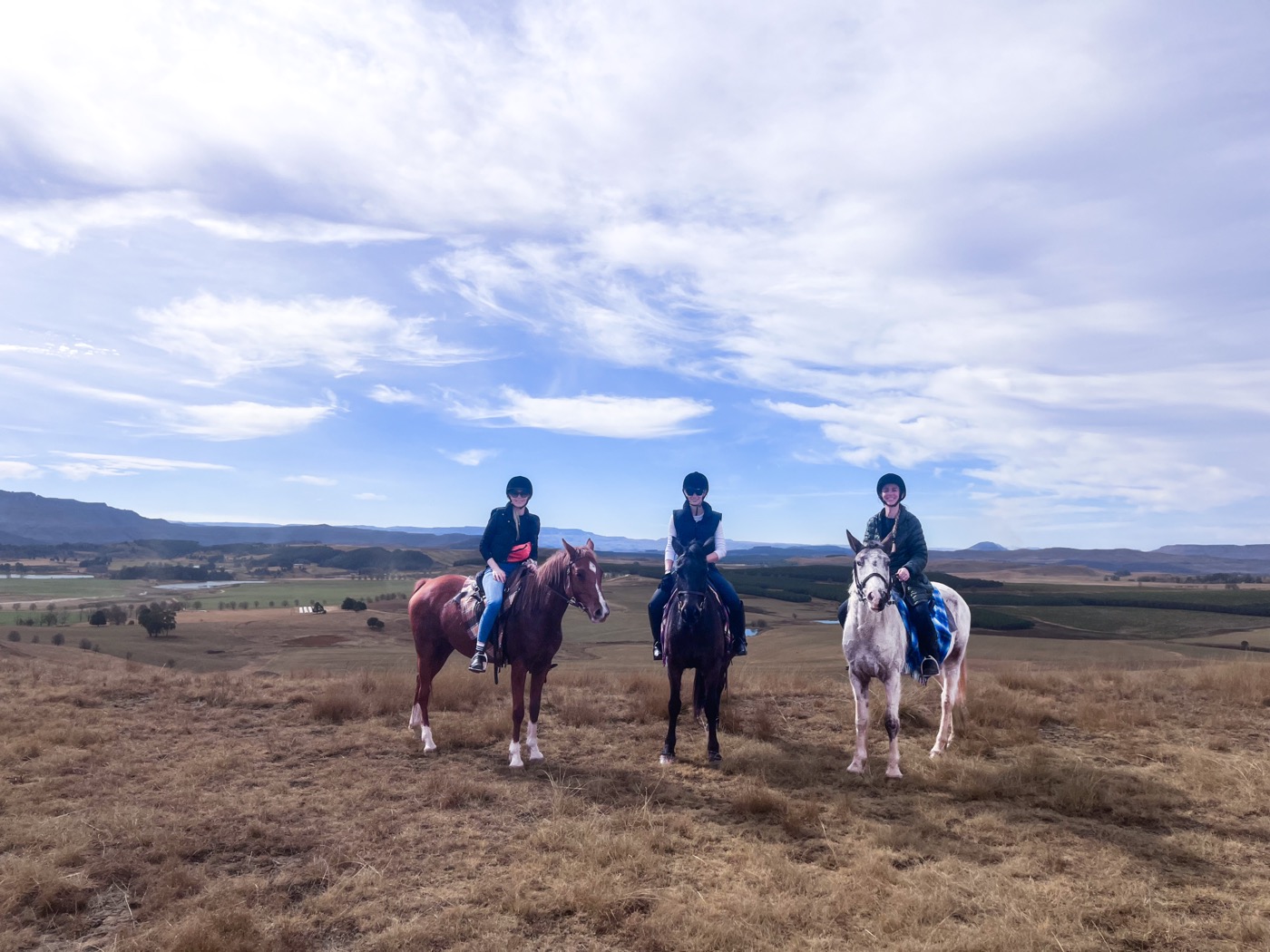 Horse riding at Khotso with Drakensberg views